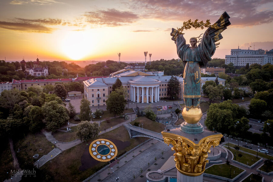 Widok z góry na wieczorny Kijów. Budowle i pomniki w świetle zachodzącego słońca