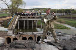 Na tle zniszczonego mostu gra waltornista orkiestry symfonicznej a zarazem żołnierz ZSU Walerij Miroszniczenko 