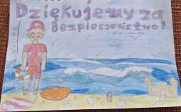 rysunek dziecka dla ratownika przedstawiający ratownika na plaży z napisem dziękujemy za bezpieczeństwo.