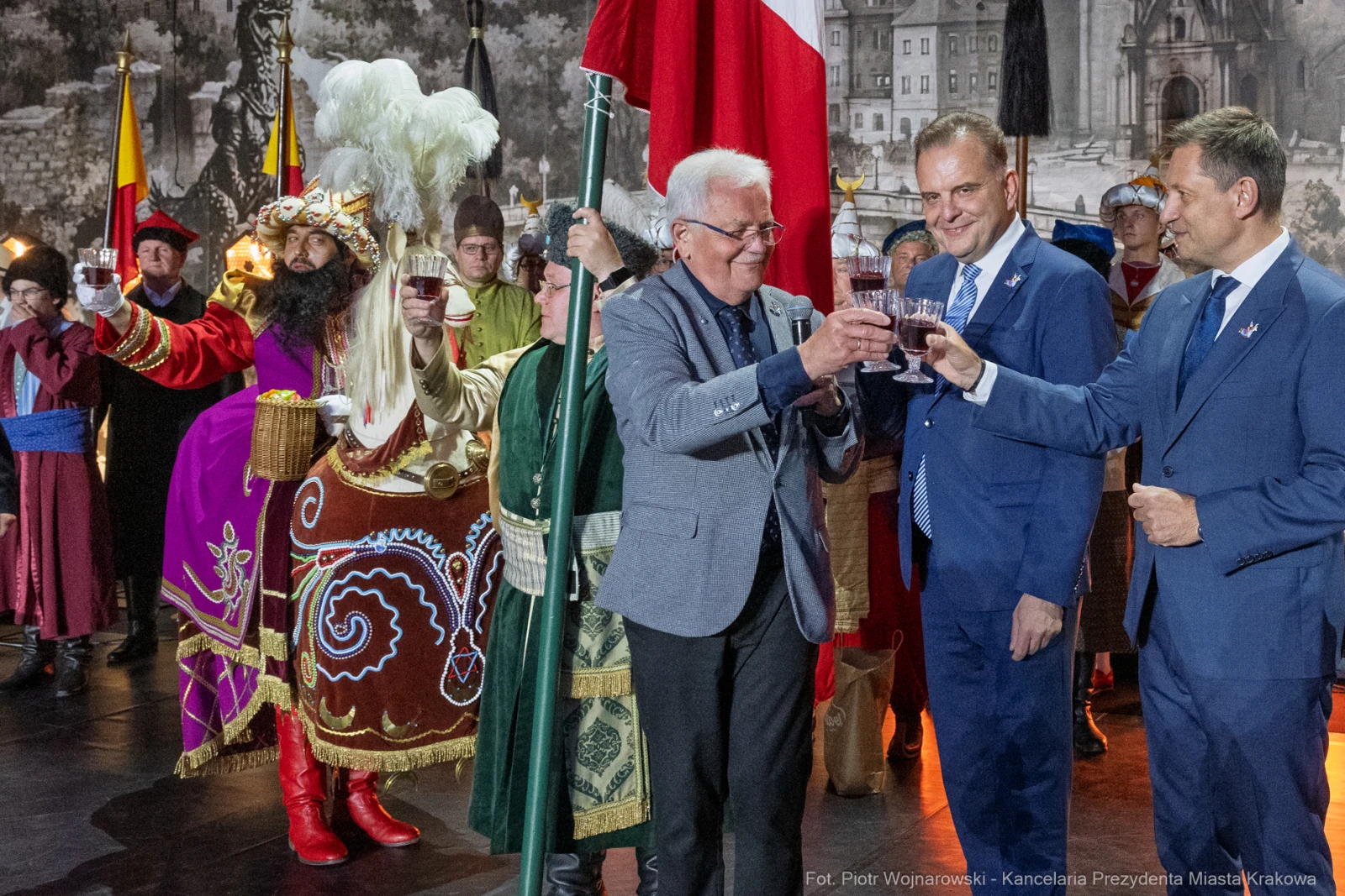 Uczestnicy wydarzenia w tradycyjnych strojach wznoszą toast.  Autor: Piotr Wojnarowski