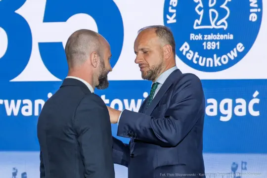 Mężczyzna odbiera odznaczenie podczas uroczystości.