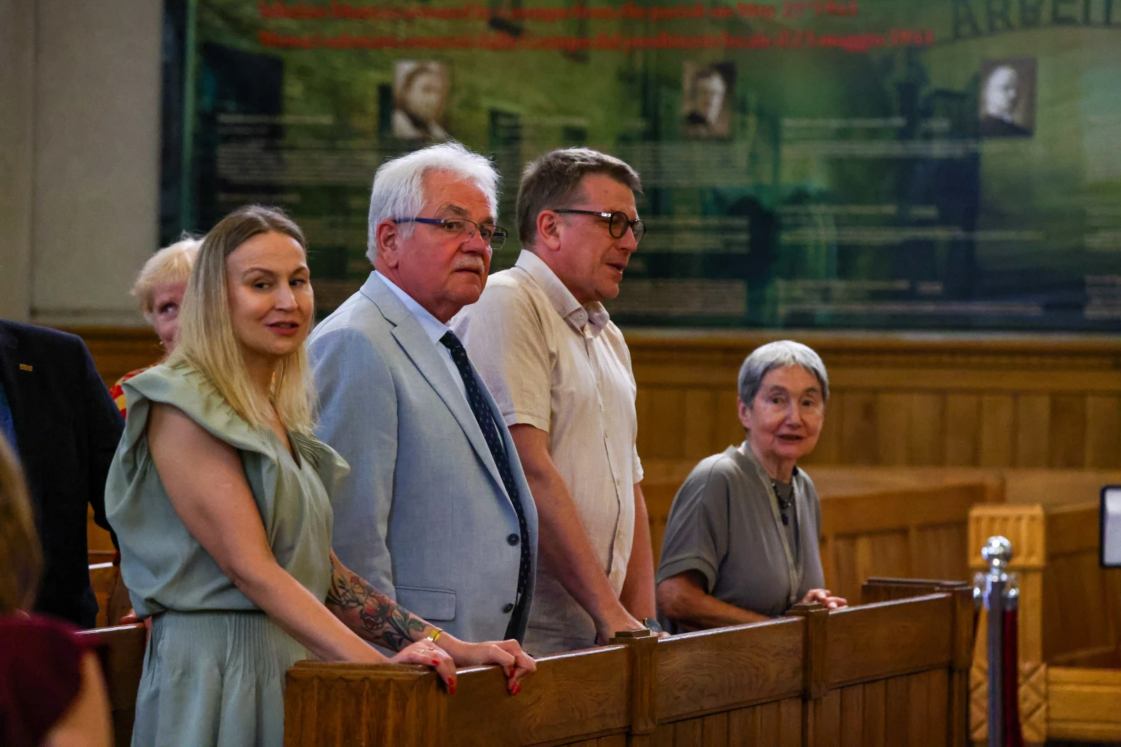 Cztery osoby stojące w sali sądowej, w tle widoczne tablice z informacjami.  Autor: Bogusław Świerzowski