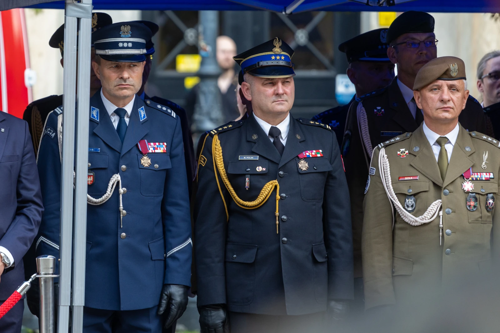 Trzech mężczyzn w mundurach wojskowych i policyjnych podczas ceremonii.  Autor: Bogusław Świerzowski