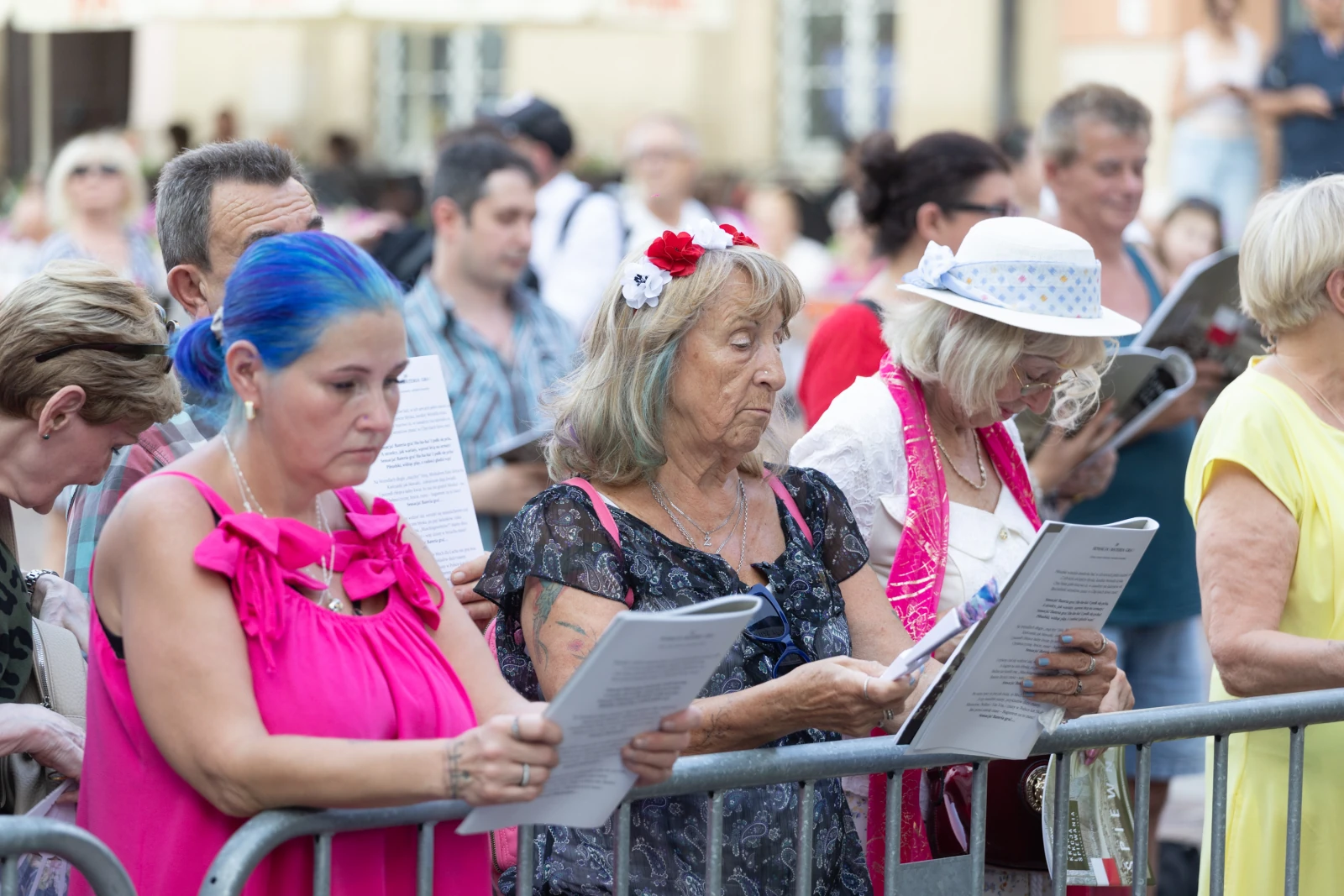 Grupa osób z kartkami w rękach, uczestniczących w wydarzeniu na świeżym powietrzu.  Autor: Bogusław Świerzowski