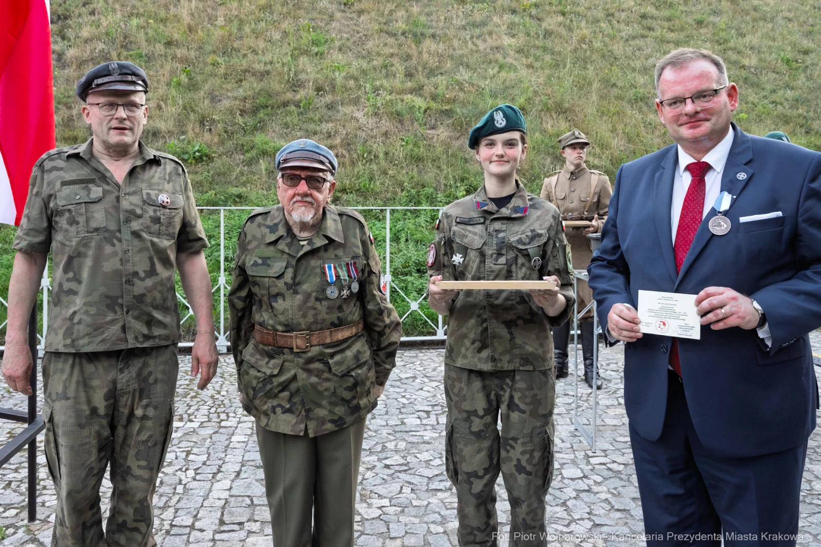 Czterech mężczyzn i jedna kobieta w mundurach wojskowych, trzymający nagrody i odznaczenia.  Autor: Piotr Wojnarowski