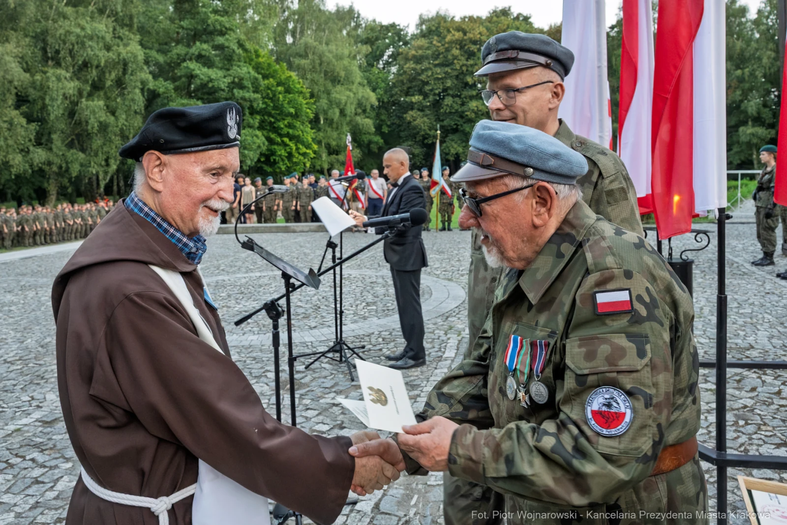 Uroczystość wręczenia odznaczeń w obecności żołnierzy i flag narodowych.  Autor: Piotr Wojnarowski