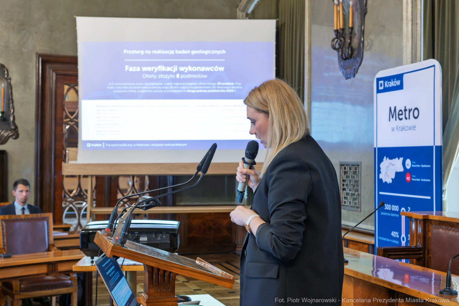 Kobieta przemawia na konferencji, w tle prezentacja dotycząca geologii i metra w Krakowie.  Autor: Piotr Wojnarowski