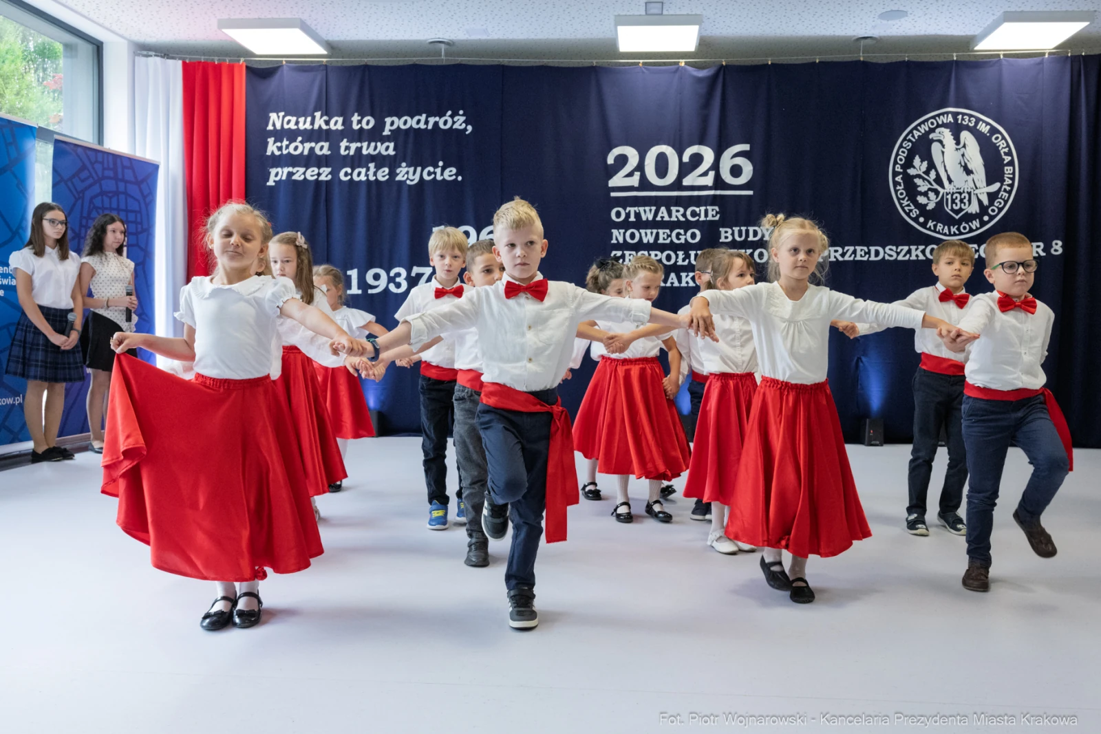 Dzieci w strojach tanecznych wykonują układ taneczny na scenie.  Autor: Piotr Wojnarowski