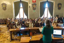 Spotkanie w sali konferencyjnej z uczestnikami siedzącymi na widowni.