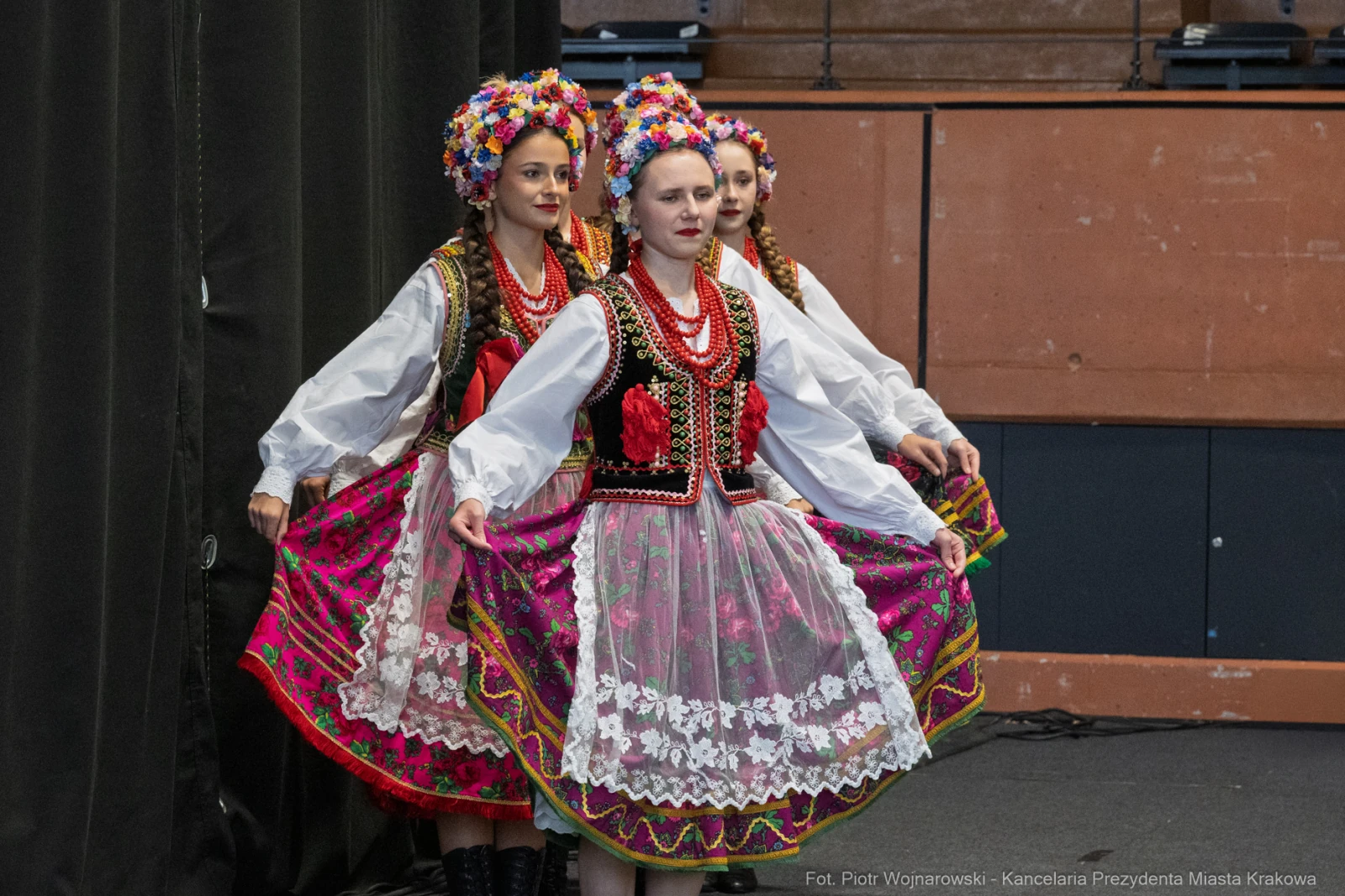 Tradycyjne polskie stroje ludowe, tancerki w kolorowych spódnicach i kwiecistych wiankach.  Autor: Piotr Wojnarowski