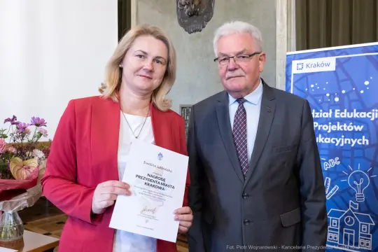 Wręczenie nagrody przez przedstawiciela miasta Krakowa. Uczestnicy z dyplomem.