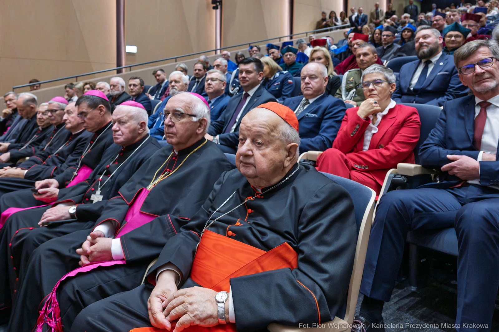 Grupa duchownych i osób w garniturach na uroczystości w sali konferencyjnej.  Autor: Piotr Wojnarowski