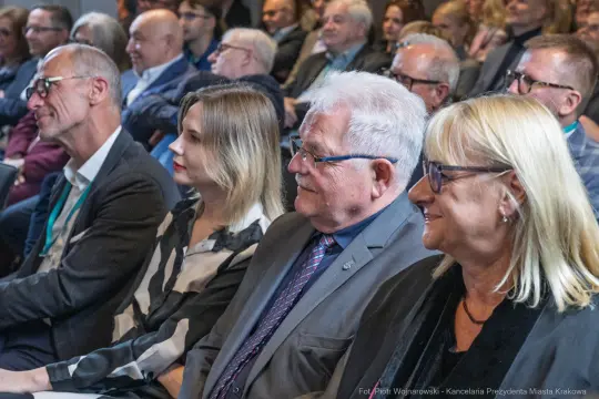 Grupa osób siedzących na widowni podczas wydarzenia.
