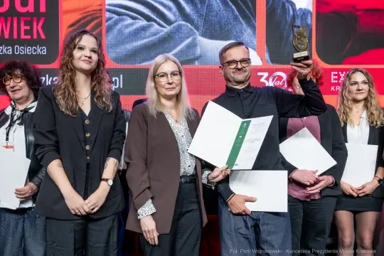 Wręczenie nagród, uczestnicy z dyplomami i statuetką.