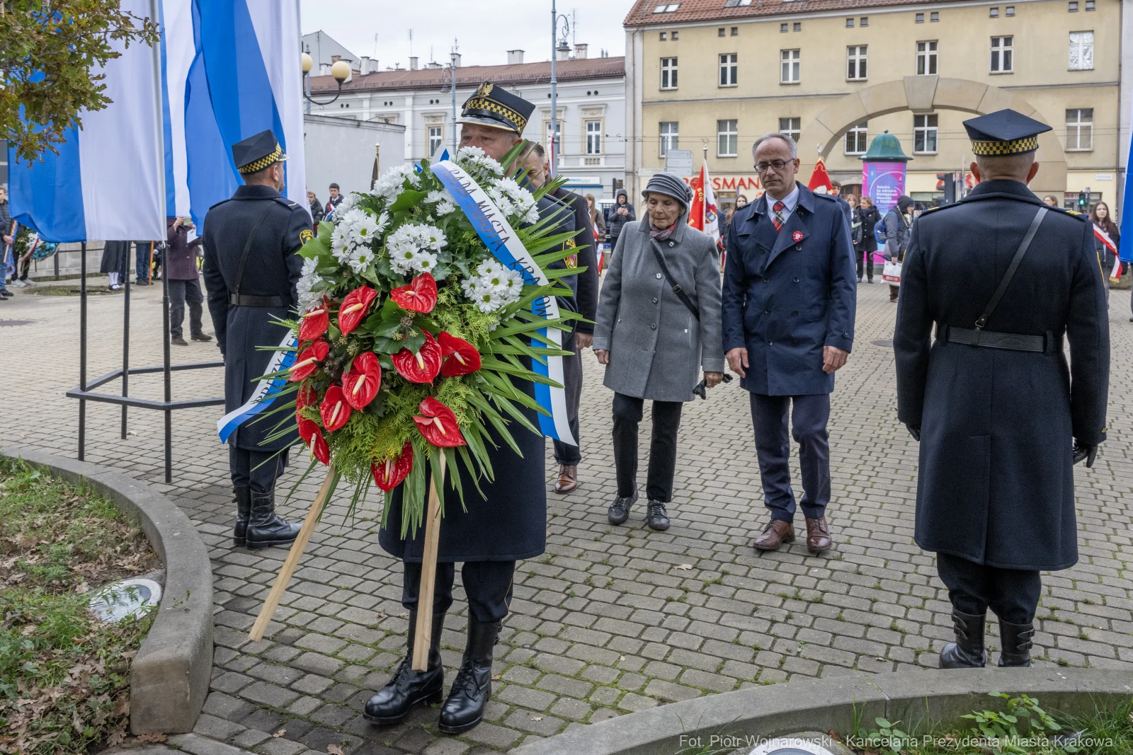Uroczystość złożenia wieńca w towarzystwie osób w mundurach i flag.  Autor: Piotr Wojnarowski