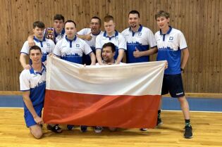 Zdjęcie przedstawia zawodników wbr groundhogs kraków z flagą polski