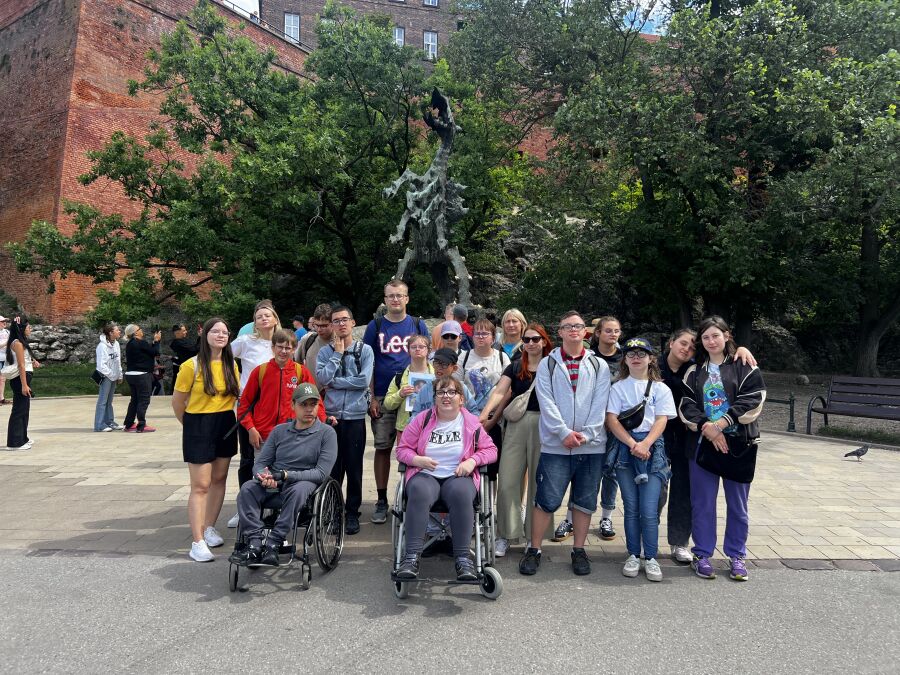 Grupa obozowiczów na wspólnym zdjęciu pod Smokiem Wawelskim.