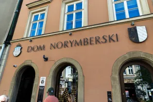 Dom Norymberski z charakterystycznym napisem i herbami na elewacji budynku.