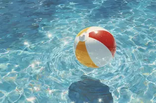 Kolorowa piłka plażowa unosi się na wodzie, odbijając światło słoneczne.
