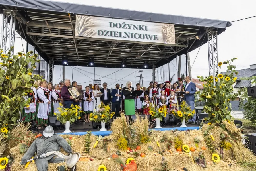 Dożynki Dzielnicowe z występami artystycznymi i dekoracjami z kwiatów oraz zboża.