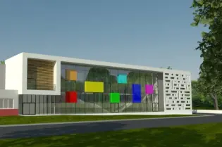 Nowoczesny budynek z kolorowymi panelami na elewacji i dużymi oknami.