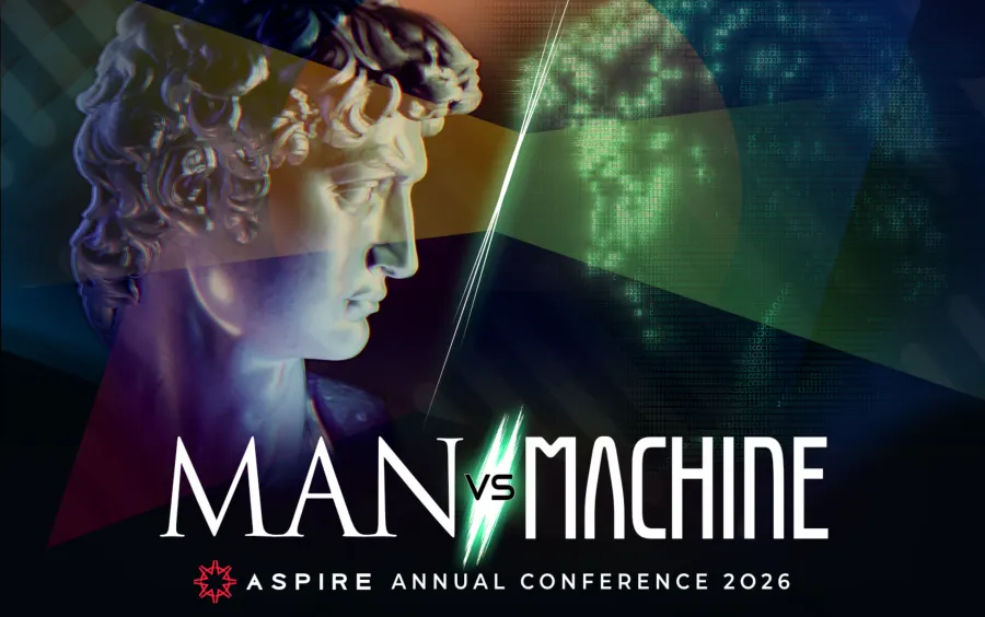 Rzeźba przedstawiająca mężczyznę z napisem Man vs Machine oraz datą konferencji 2026.