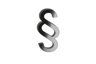 Grafika przedstawia symbol paragafu w kolorze czarno-szarym na białym tle.